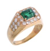 An emerald and diamond ring, the central rectangular cut emerald claw set within a surround of