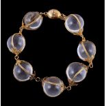 A 19th century adapted rock crystal bracelet, the polished rock crystal spheres encased in filigree