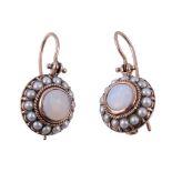 A pair of opal and pearl earrings, the central circular cabochon opal collet set within a surround