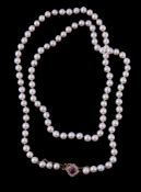 A cultured pearl necklace with ruby and diamond clasp, the one hundred and four uniform cultured