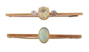 An Edwardian opal brooch, the oval cabochon opal in a collet setting, on a polished bar, stamped