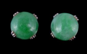 A pair of jadeite jade ear studs, the circular cabochon jadeite jade in four claw settings, with