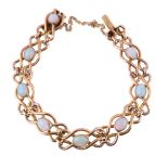 An Edwardian gold and opal bracelet, the oval cabochon opals on a polished looped link bracelet, to