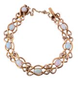 An Edwardian gold and opal bracelet, the oval cabochon opals on a polished looped link bracelet, to