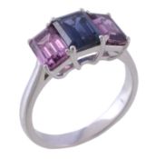 A three stone sapphire ring, the central rectangular cut sapphire between two rectangular pink