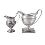 A George III pedestal cream jug by John Schofield, London 1795, with a reeded loop handle, a cape