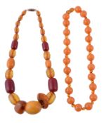 An amber bead necklace, the circular amber beads with smaller amber beads in between, with a screw