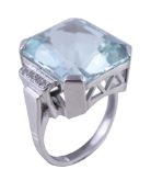 An aquamarine and diamond dress ring, the fancy cut aquamarine in a four claw setting, between