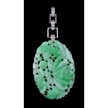 A 1950s jadeite jade and diamond pendant, the oval jadeite jade panel carved with foliage,