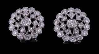 A pair of diamond cluster earrings, the pierced circular panels set with brilliant cut diamonds and