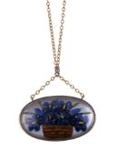 A reverse painted intaglio pendant, the oval painted reverse painted with a basket of iris flowers,
