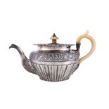 A George IV silver circular baluster tea pot, maker's mark obscured, London 1824, with an ivory