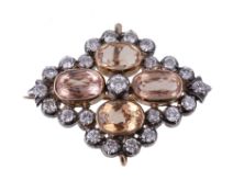 A Victorian topaz and diamond brooch/pendant, the four oval cut topaz centering a brilliant cut