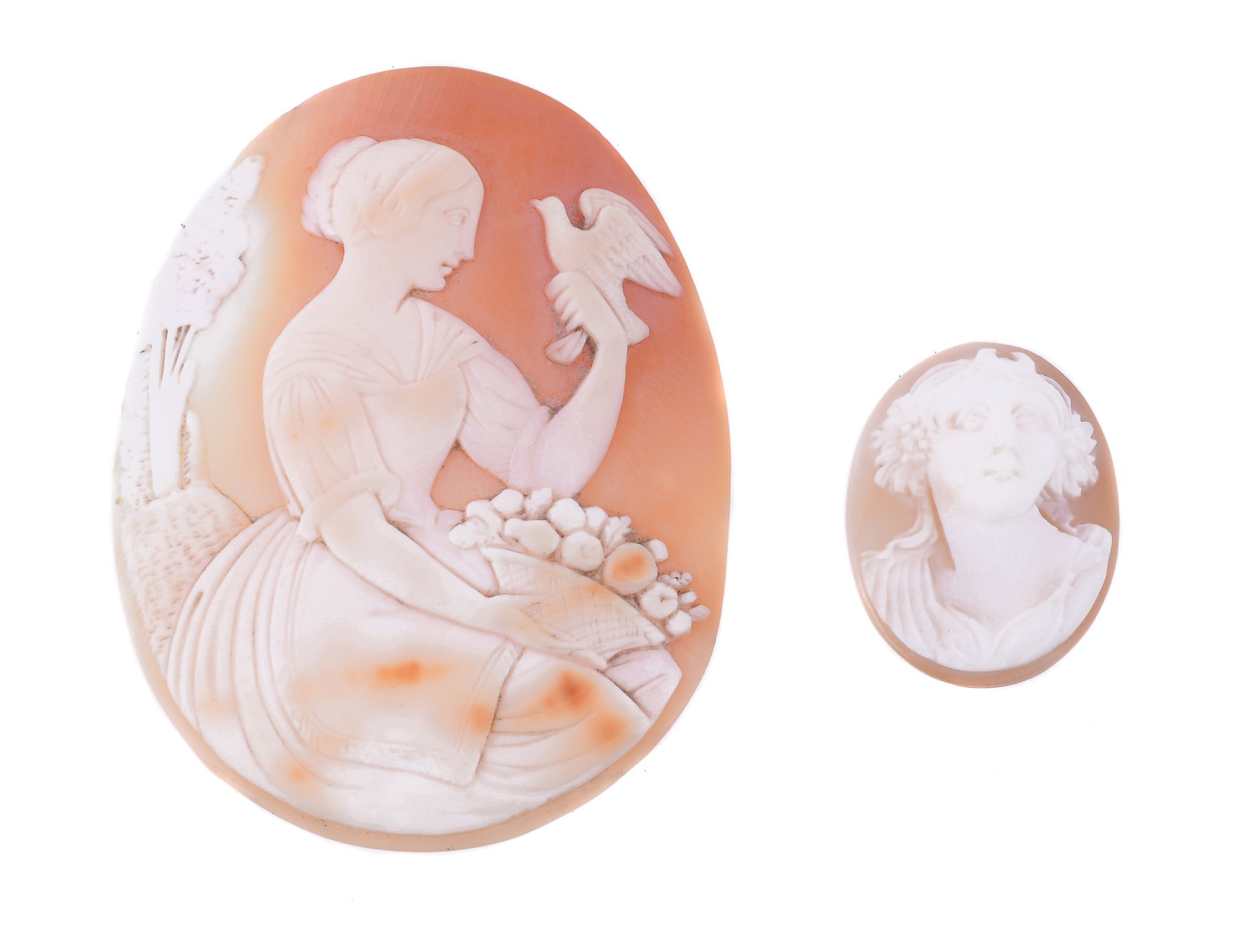 An unmounted shell cameo, the oval panel carved with a maiden holding a dove, with a basket of