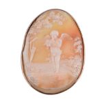 A Victorian shell cameo brooch, the oval panel carved with cupid standing cradling a dove, his