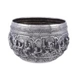 A late 19th century Burmese silver bowl, chased and embossed with Jataka scenes between decorative