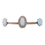 A late Victorian opal and diamond bar brooch, circa 1890, the central oval cabochon opal within a