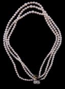 A three strand cultured pearl necklace, the three strands composed of slightly graduating cultured