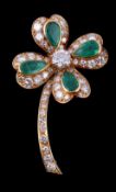 A diamond and emerald four leaf clover brooch, the central brilliant cut diamond, estimated to