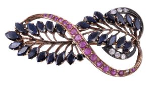 A ruby, sapphire and diamond brooch, the stylised foliate brooch set with circular cut rubies,