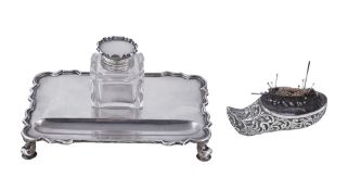 A silver novelty pincushion by Nathan & Hayes, Chester 1912, formed as a scroll embossed clog, 8.