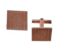 A pair of gold coloured cufflinks, the square panels with linear detail, with t-bar fittings,
