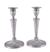 A pair of silver candlesticks by Roberts & Dore Ltd., London 1973, with oval beaded sconces, urn
