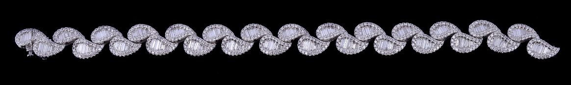 A diamond bracelet, the tear drop shaped panels set with baguette cut and brilliant cut diamonds,