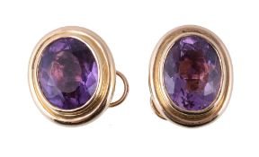 A pair of amethyst earrings, the oval cut amethysts in collet settings, with post fittings, stamped