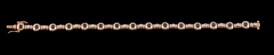 A sapphire and diamond bracelet, composed of alternating circular cabochon sapphires and brilliant