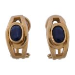 A pair of sapphire earrings, the slightly curved panels set with an oval cut sapphire, with post