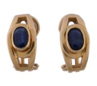 A pair of sapphire earrings, the slightly curved panels set with an oval cut sapphire, with post