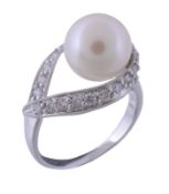 A cultured pearl and diamond ring, the cultured pearl set within a surround of brilliant cut
