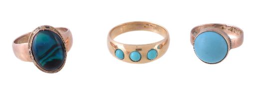 A three stone turquoise ring, set with three circular cabochon turquoise on a polished band, finger