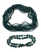 A multi strand malachite bead necklace, the seven strands of uniform malachite beads with gold