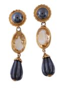 A pair of citrine and haematite earrings, the reeded haematite drops suspended from an oval cut