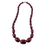 An amber bead necklace, composed of graduating 1.1cm to 2.9cm oval amber beads, with a screw clasp,