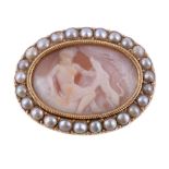 A 19th century shell cameo brooch, the oval shell carved with a seated lady and a hound beneath a