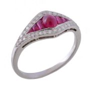 A ruby and diamond ring, the central oval cabochon ruby between calibre cut rubies, within a