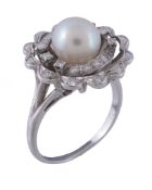 A cultured pearl and diamond dress ring, the central cultured pearl within surround of eight cut