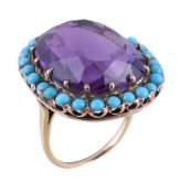 An amethyst and turquoise ring, the cushion cut amethyst claw set within a surround of circular