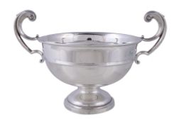 A silver twin handled trophy cup by Levesley Brothers, Sheffield 1914, with tongue-capped double