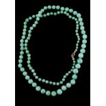 A jadeite jade bead necklace, the graduating circular jadeite jade beads on a knotted string, 83cm