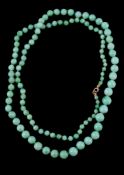 A jadeite jade bead necklace, the graduating circular jadeite jade beads on a knotted string, 83cm
