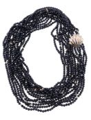 A multi strand onyx bead necklace, the seven strands composed of uniform polished onyx beads, with