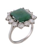 An emerald and diamond cluster ring, the central rectangular cut emerald claw set within a surround