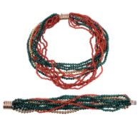 A malachite and coral multi strand necklace, composed of polished malachite and coral beads with a