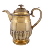 A late George III silver gilt coffee jug by John Wakefield, London 1819, the lobed button finial