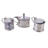 Three silver mustard pots, to include: a late Victorian circular drum mustard pot by John William