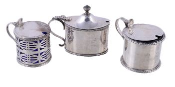 Three silver mustard pots, to include: a late Victorian circular drum mustard pot by John William